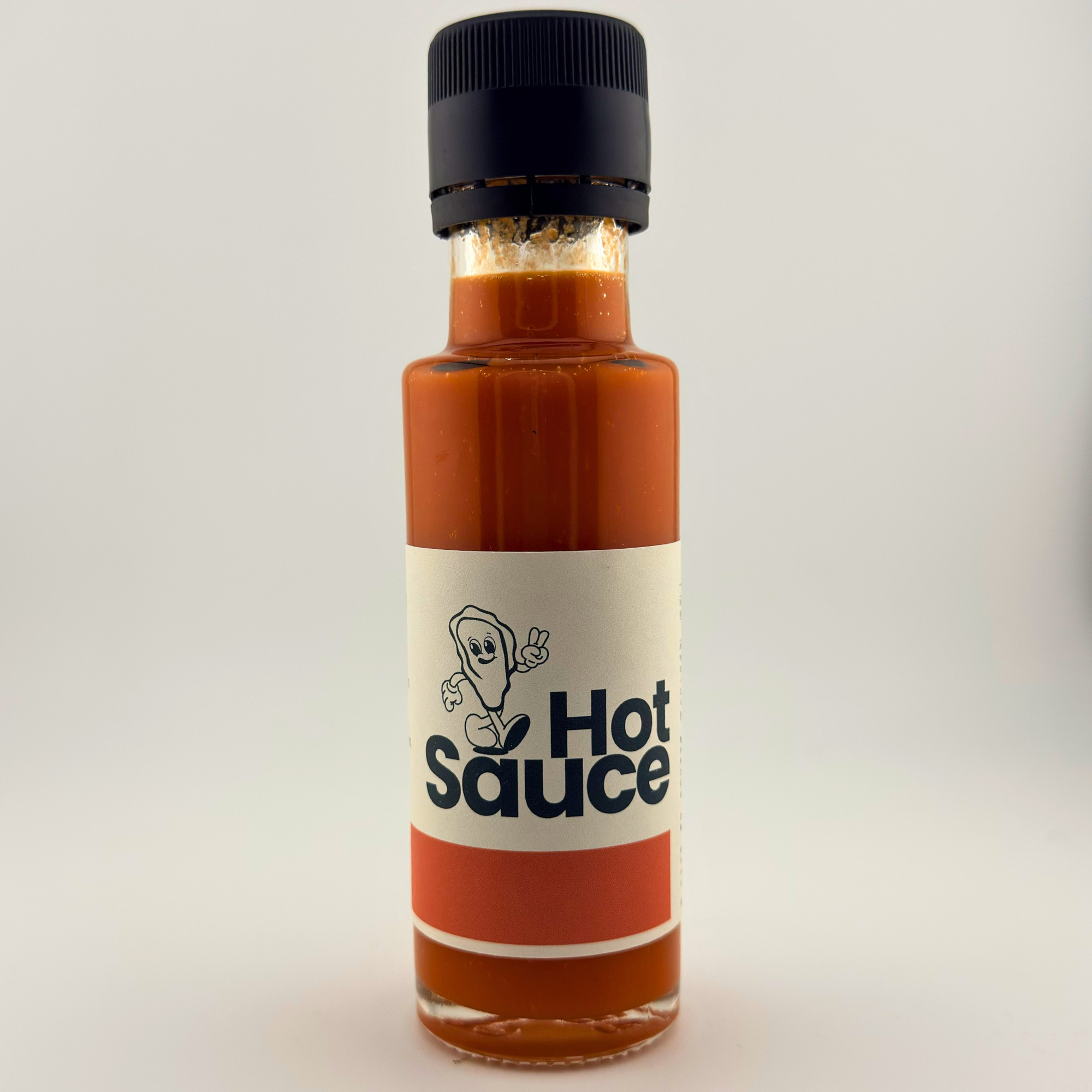 Bottle of hot sauce with a label on a white background