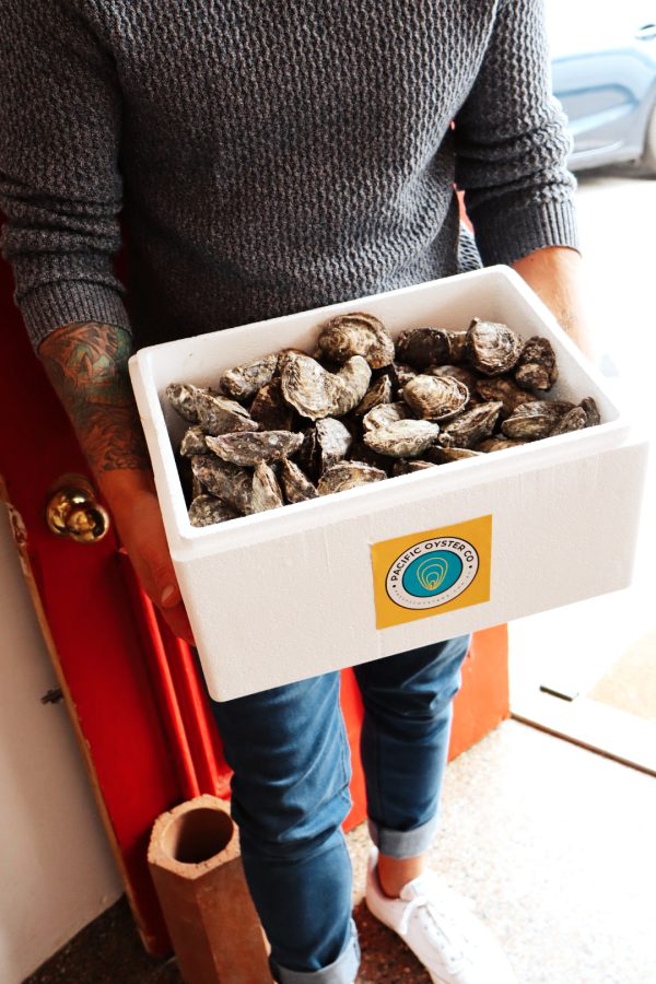 Popup shop photo holding box of oysters